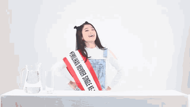 a woman wearing a sash that says ' member single ke-t ' on it