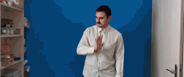 a man in a white shirt has a mustache on his face