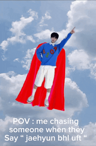 a man with a red cape is flying through the sky