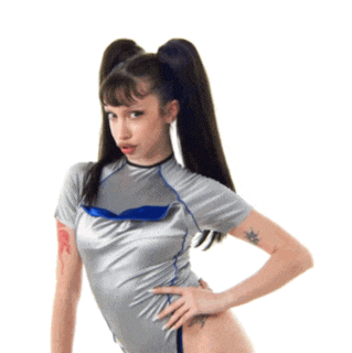 a woman with a tattoo on her arm is wearing a silver top