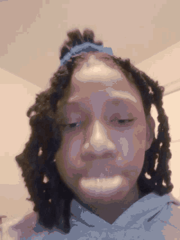a close up of a person 's face with a blue headband