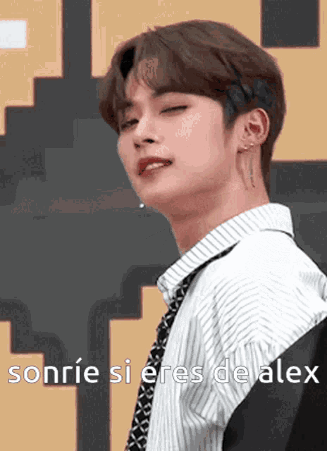 a young man wearing a striped shirt and tie is smiling with the words sonrie si eres de alex below him