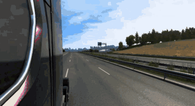 a truck is driving down a highway with a sign that says ' a ' on it