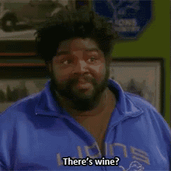 a man with a beard wearing a blue jacket that says there 's wine