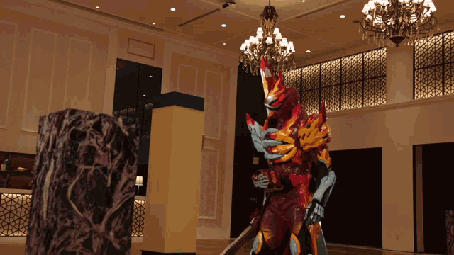 a statue in a room with a chandelier and pillars