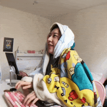 a woman wrapped in a blanket with the letter m on it