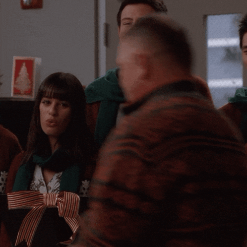a group of people wearing scarves are singing