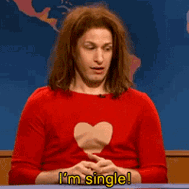 a man in a red shirt with a heart on his chest says i 'm single