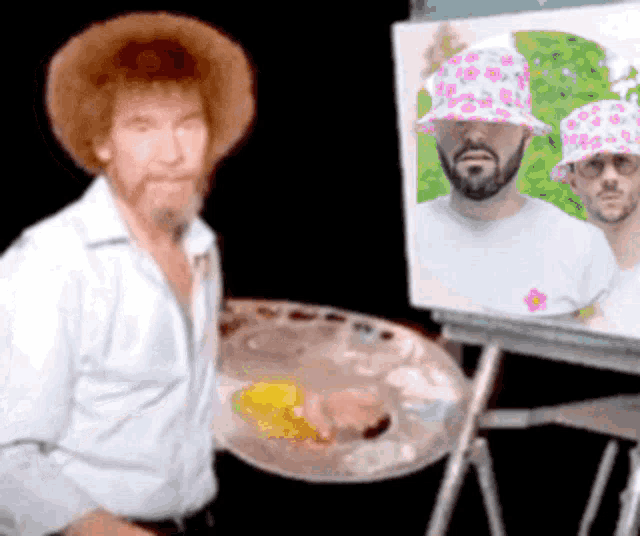 bob ross is painting a picture of two men wearing hats