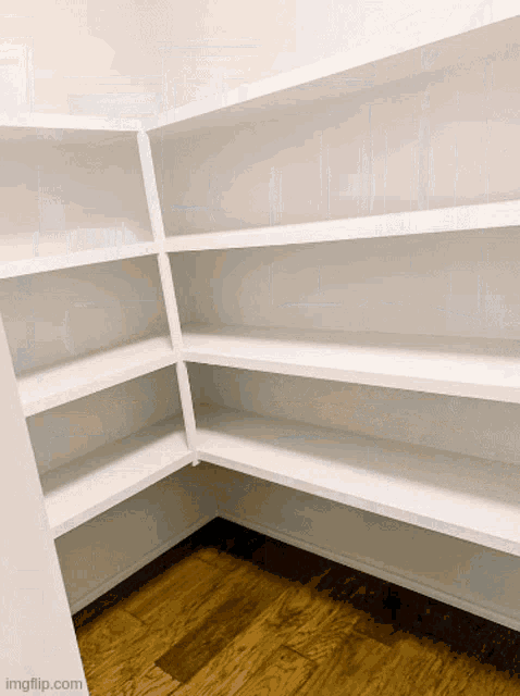 empty shelves in a closet with a wooden floor