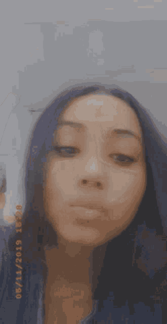 a close up of a woman 's face with the date 06 11 2019 on the bottom