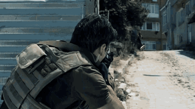 a man in a military uniform is holding a gun and wearing a backpack with the word 5.11 on it