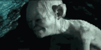 a close up of a gollum from the lord of the rings making a face .