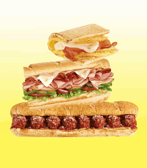 three sandwiches are stacked on top of each other including meatballs and eggs