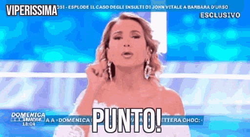 a woman in a white dress is on a television screen with the words punto written on it