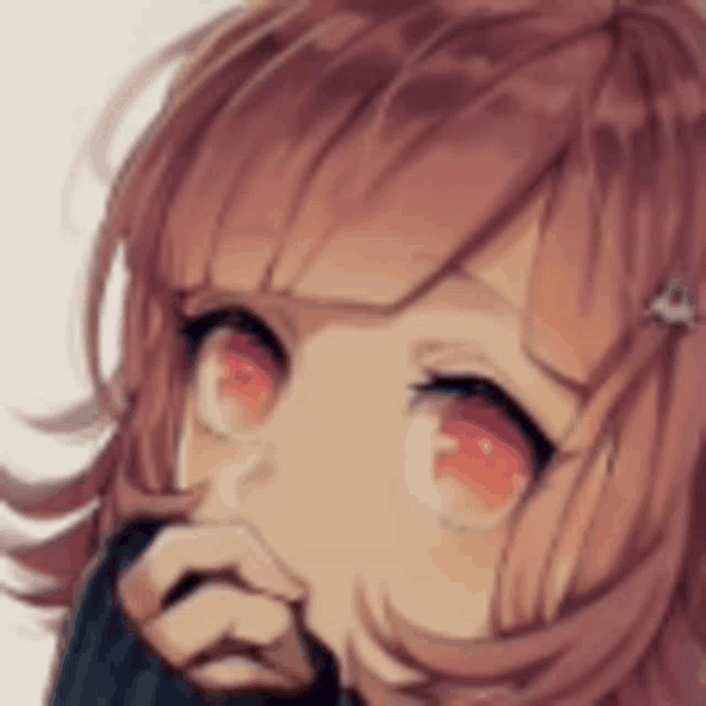 a close up of a girl with red eyes covering her mouth with her hand .
