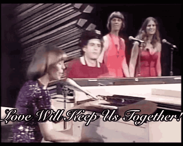 a group of people singing and playing a piano with the words love will keep us together above them