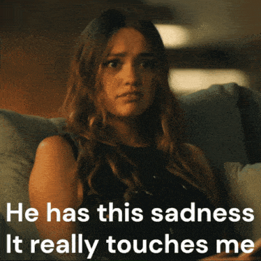 a woman sits on a couch with the words he has this sadness it really touches me
