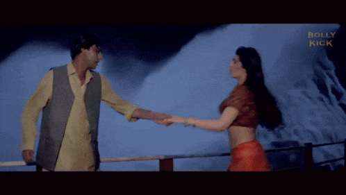 a man holds a woman 's waist in front of a waterfall and the words bolly kick are visible