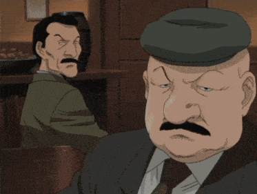 two men sitting at a table with a mug of beer