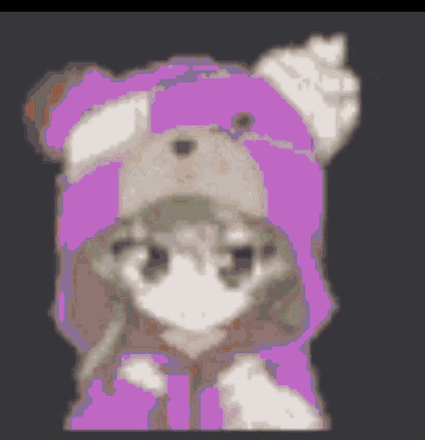 a girl wearing a purple teddy bear hat and hoodie .