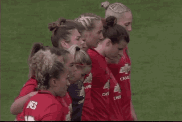 a group of female soccer players are huddled together and one of them has the name mes on her jersey
