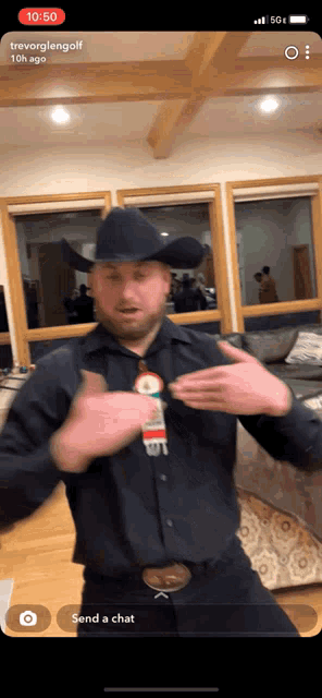 a man in a cowboy hat is dancing on a phone screen with the time of 10:50