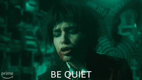 a woman with blood on her face and the words " be quiet " above her