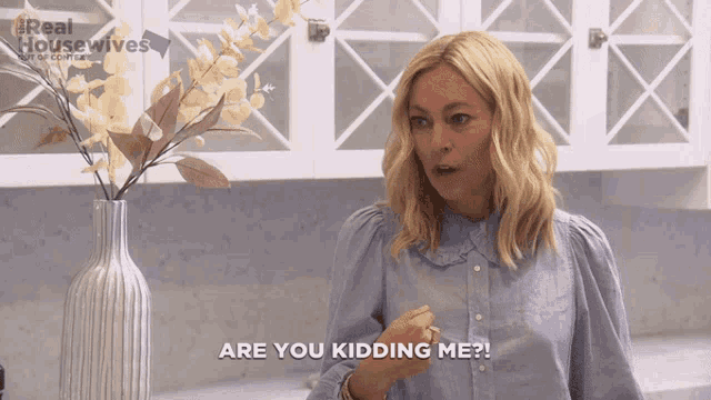 a woman says " are you kidding me " in front of a vase