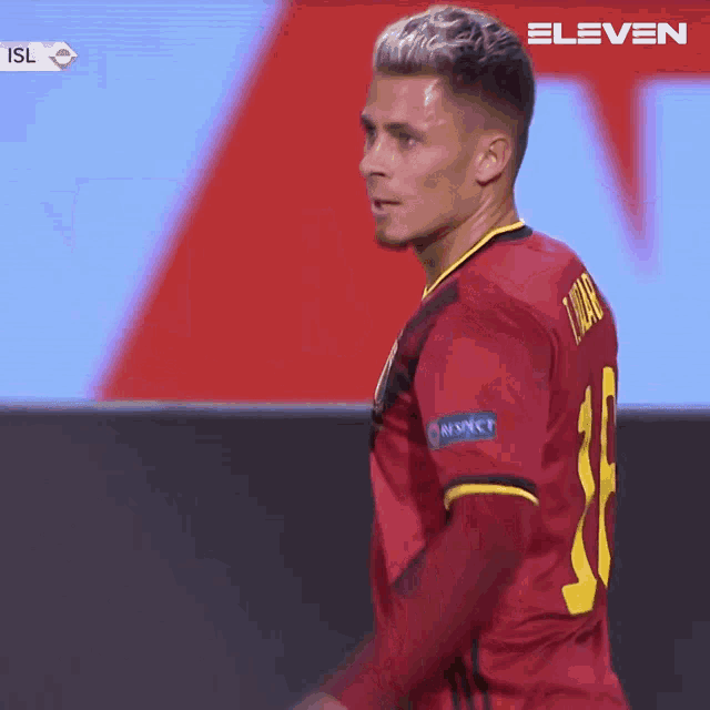 a soccer player wearing a red jersey that says respect