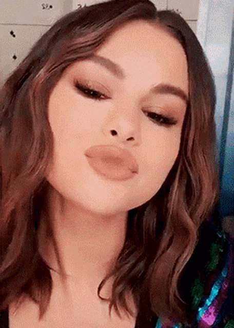 a close up of a woman 's face making a funny face .
