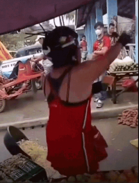 a woman in a red dress is standing in front of a cart that says hot foo on it