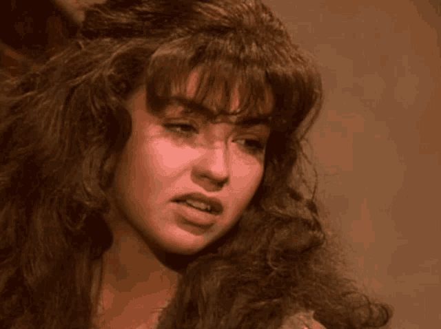 a close up of a woman 's face with long hair