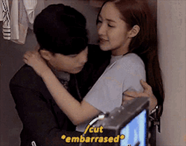 a man and a woman hugging with the words cut embarrassed