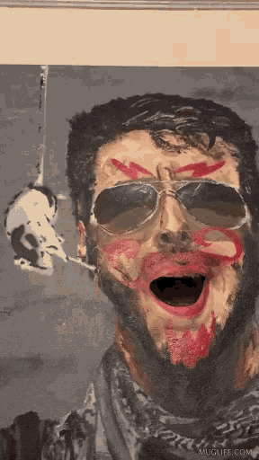 a painting of a man with sunglasses and red paint on his face is on muglife.com