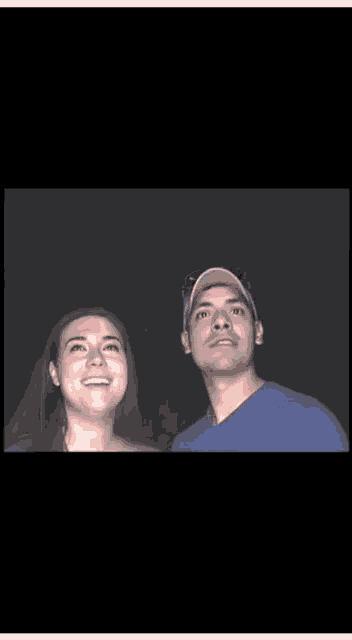 a man and a woman are looking into each other 's eyes
