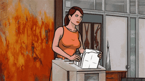 a woman is holding a piece of paper in front of a fire wall .