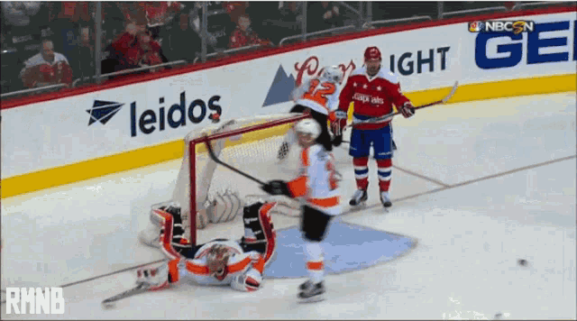 a hockey game is being played in front of an advertisement for leidos