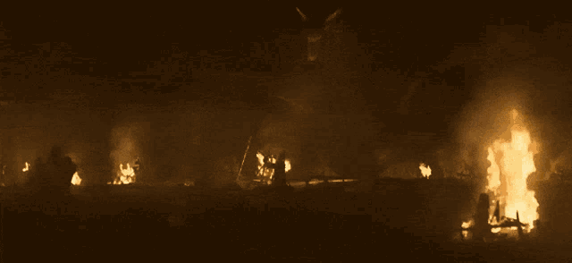 a large fire is burning in the dark