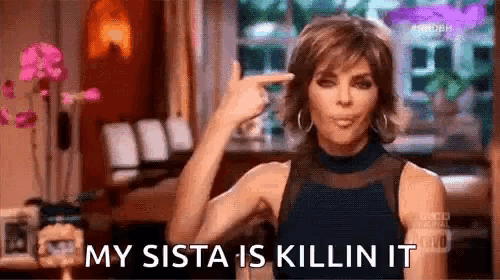 a woman is pointing her finger at her head and says `` my sista is killin ' it '' .