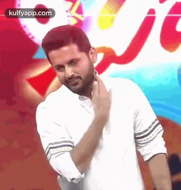 a man in a white shirt is making a funny face .