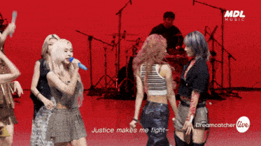 a group of women singing and dancing in front of a red background with the words justice makes me fight