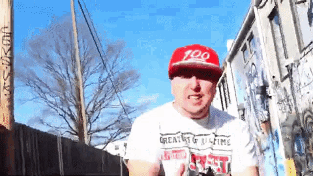a man wearing a red hat and a white shirt that says great at all times