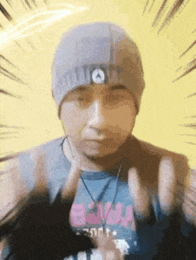 a man wearing a beanie and a t-shirt that says brava