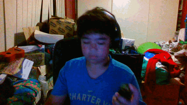 a boy wearing headphones and a blue shirt with the word charter on it