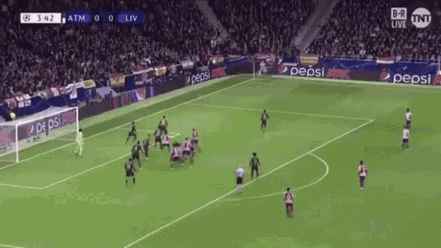 a soccer game is being played on a field with pepsi ads on the sidelines