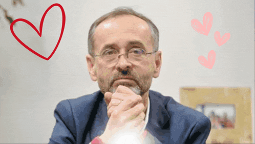 a man with a beard and glasses is surrounded by hearts