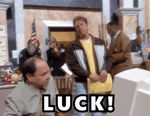 a man sitting in front of a computer with luck written on the screen