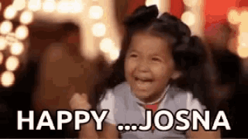 a little girl is laughing with the words `` happy josna '' written on the screen .