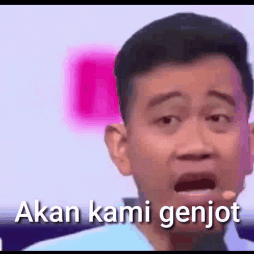 a man is talking into a microphone with his mouth open and the words akan kami genjot .